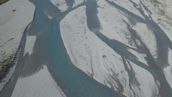 Shallow water of river in terrain with mountains