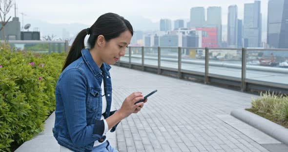 Woman work on smart phone at outdoor