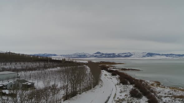 Flying over a farm near the shoreline of Utah Lake near Lincoln Beach, looking toward the west mount