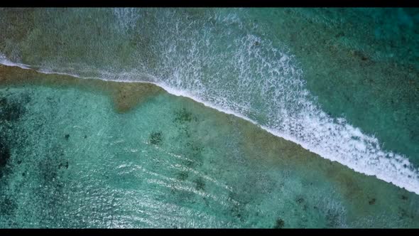 Aerial top view seascape of idyllic island beach time by turquoise ocean and bright sandy background