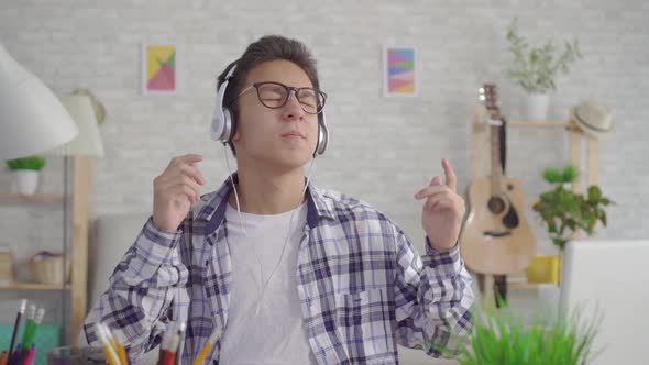 Portrait Young Asian Man Listening Energetic Music with Headphones