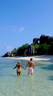 Anse Source d'Argent La Digue Seychelles Young Couple Men and Woman on a Tropical Beach During a