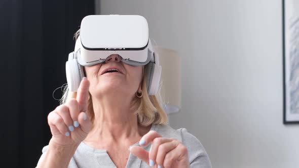 An Old Grandmother Relaxes in Virtual Reality Glasses