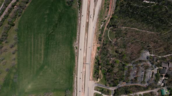 Aerial Following Video of a Spring Highway Above the Riverside