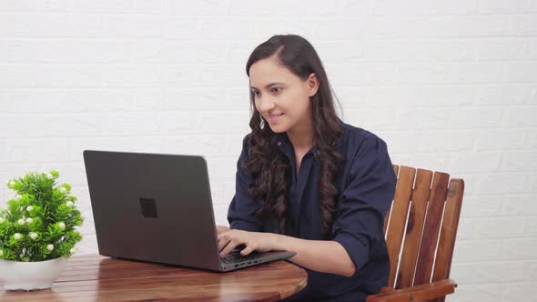 Indian girl relaxes after finshing up a work