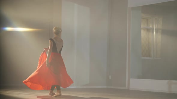 Caucasian Female Ballet Dancer Rehearsing in Slow Motion Spinning on Tiptoes in Backlit Fog Looking