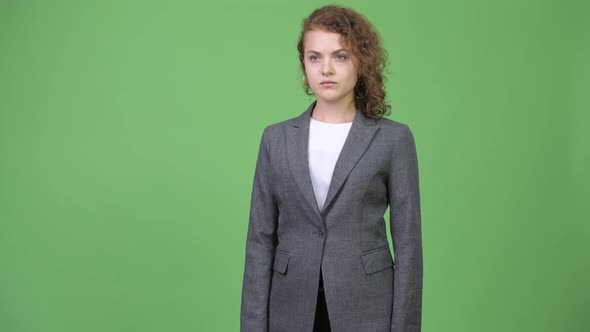 Young Beautiful Businesswoman with Curly Blond Hair Thinking