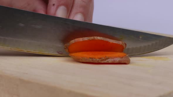 Close Up   Slicing A Small Turmeric On Cutting Board