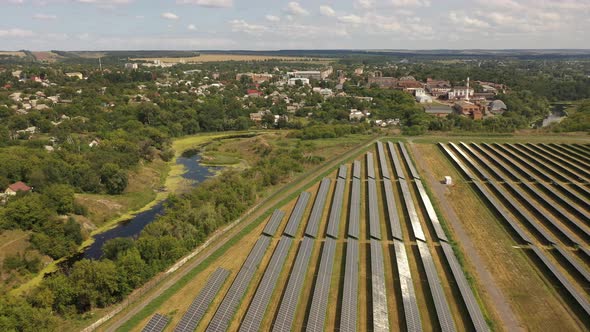 Aerial view of the Solar panels on a hill above the river