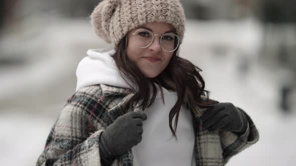 Funny Woman with Glasses and Knitted Hat Outdoor at Winter Day Portrait of Grimacing Lady