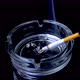A smoking cigarette in a glass ashtray - VideoHive Item for Sale