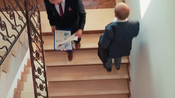 Top View of Company Manager Walking Up the Stairs