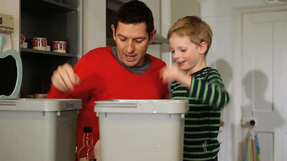 MS Father and son putting recyclable materials into recycling bins / London, United Kingdom