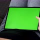 Big tablet green screen display in female lap 4K footage - VideoHive Item for Sale