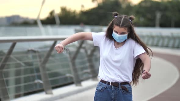 Active Teenage Girl in Face Mask Dancing Outdoors