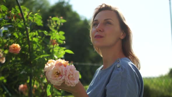 Portrait of a Girl in a Rustic Garden with Yellow Roses