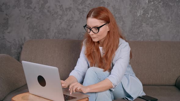 Ginger Student Using Computer at Home