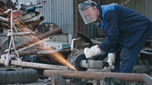 Worker with Grinder Cutting Metal