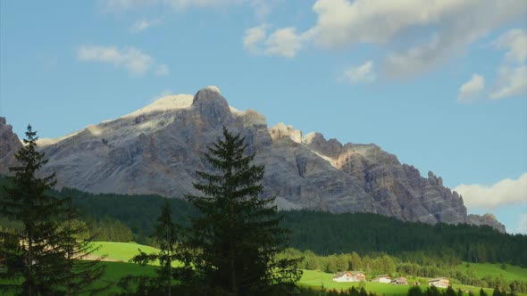 Clouds rolling above mountain landscape, Alta Badia, Italy