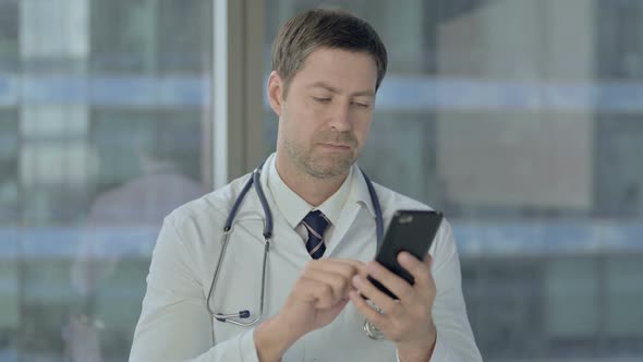 Middle Aged Doctor Using Smartphone, Scrolling