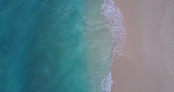 Beautiful drone clean view of a white sandy paradise beach and turquoise sea background in hi res 4K