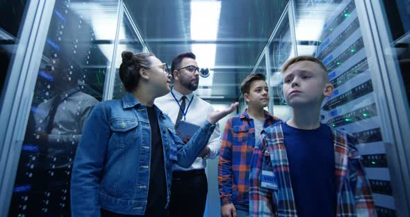 IT Technician Showing Around Children in a Server Park