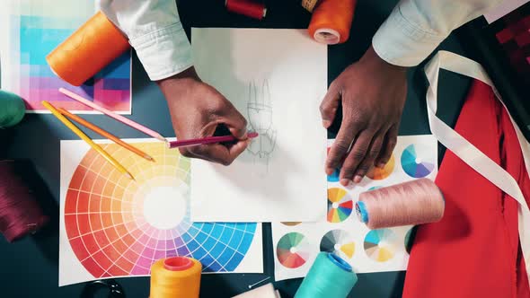 Designer is Sketching a Piece of Clothes in a Top View