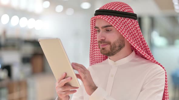 Portrait of Attractive Arab Businessman Using Digital Tablet