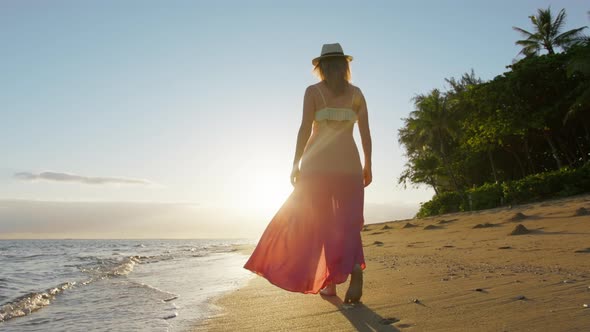 Summer Vacation on Paradise Island Young Woman Walking Towards Golden Sunrise