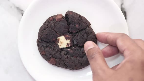 Hand Pick Chocolate Cookies on Plate