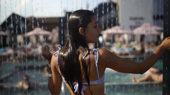 Beautiful Girl In Swimwear Showering Under Water At Resort Beach