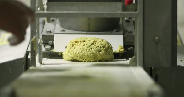 Making Bread In Bakery - Hand Of Baker Taking The Raw Yellow Rounded Dough From The Dough Rolling Eq