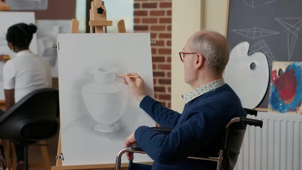 Elder Person in Wheelchair Creating Vase Drawing on Canvas