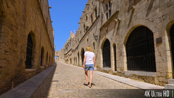 4K Rear View of Woman Walking Down Empty Street of Knights on the Greek Island of Rhodes