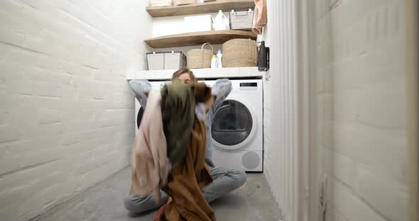 Housewife Throwing Up Clothes at the Laundry