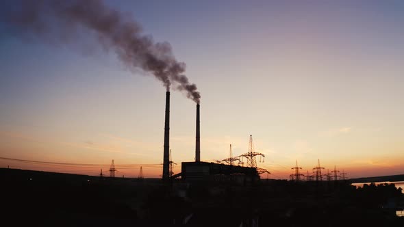 Factory tubes on the sunset background