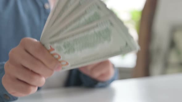 Close Up of Male Hand Giving Dollars