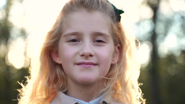 Blond Girl Looking at Camera in Countryside