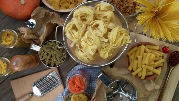 Various Types of Raw Pasta Rotate Slowly. Macro Background. View From Top