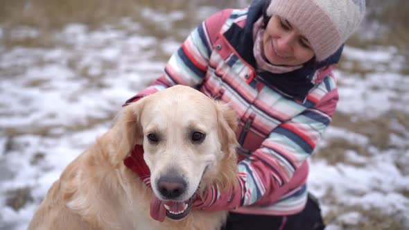 Woman Stroking Dog on Winter Nature