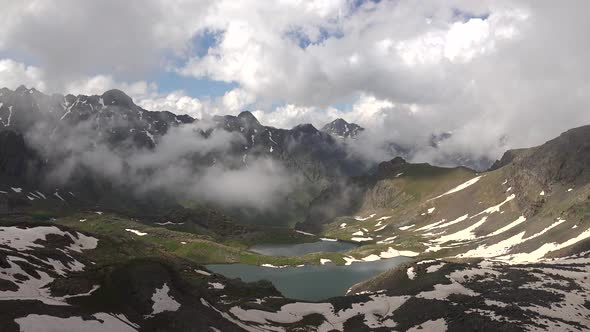 Clouds Passing Through the Valley to the High Altitude Alpine Lake