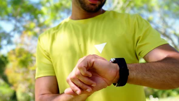 Man using smartwatch in park