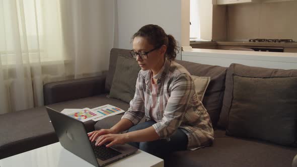 Moving Shot of Adult Female Freelancer in Eyeglasses Working at Home