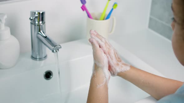 A Child Washes Hands with Soap Little Girl Hands Washing to Prevention Diffusion of Virus and