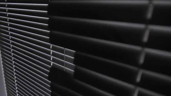 Blinds on a Window in a Dark Room Against the Light