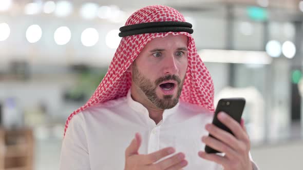 Upset Arab Businessman Having Loss on Smartphone 