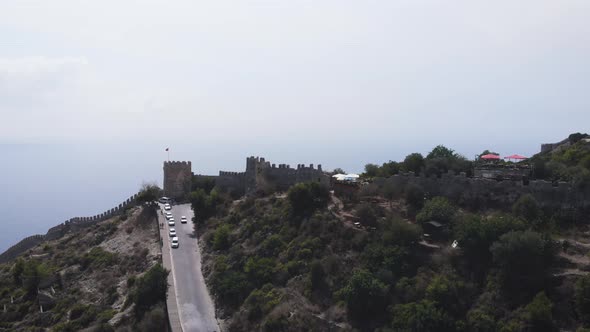 Turkish flag over old castle Alanya Kalesi Old fortress, Alanya, Turkey. Mountain, construction.