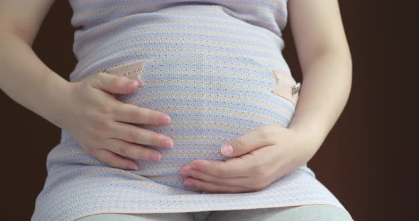 Pregnant women caressing her belly