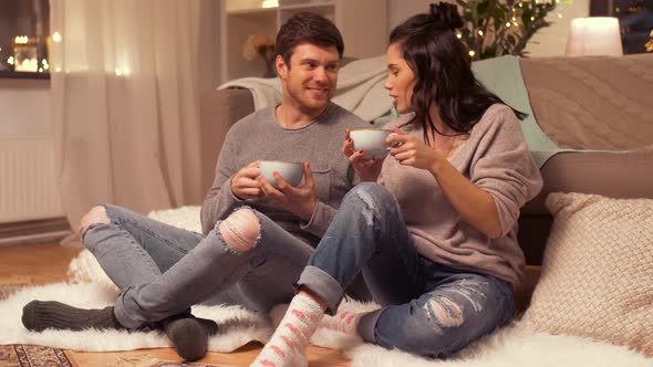Happy Couple Drinking Hot Chocolate at Home