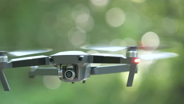 Drone Copter with Blurred Propellers and Video Camera Flying in Air